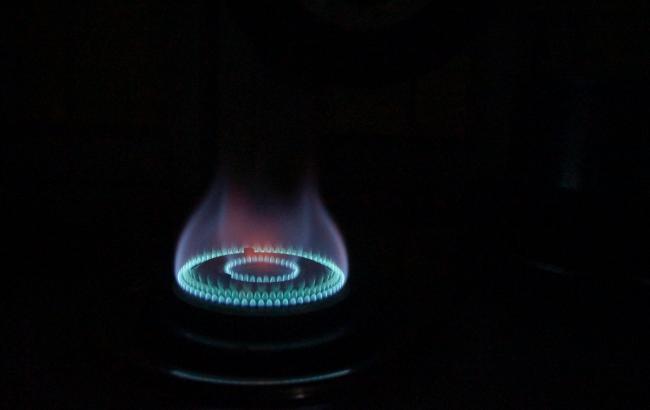 Dark background and a cooker burner on. Photo by Ayesha Firdaus on Unsplash